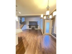 Langley apartment for rent - A spacious living room with a fireplace and a staircase.
