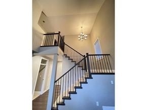 Langley apartment for rent - A staircase with a black railing and wooden steps.