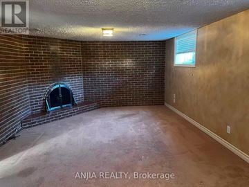 Mississauga (Erindale) apartment for rent - A room with a brick wall and a fireplace.