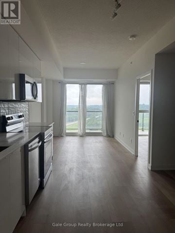 Brantford condo for rent - A spacious kitchen with a dishwasher and a window overlooking the outdoors.