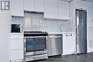 Toronto (Church-Yonge Corridor) condo for rent - A modern kitchen with white cabinets and stainless steel appliances.