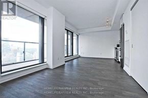 Toronto (Church-Yonge Corridor) condo for rent - A spacious room with a large window and a view of the city.