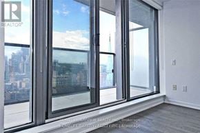 Toronto (Church-Yonge Corridor) condo for rent - A room with a view of the city through large windows.