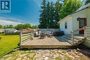 Vittoria apartment for rent - A wooden deck with a table and chairs is in the foreground of a sunny day.