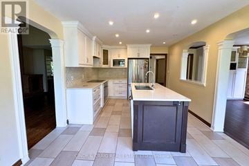Pickering (Woodlands) apartment for rent - A kitchen with a white counter top and a black island.
