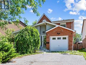 Pickering (Amberlea) apartment for rent - A house with a white garage door and a brick facade.