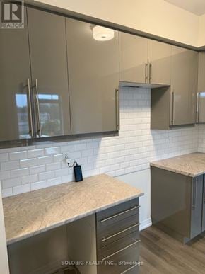 Brantford townhouse for rent - A kitchen with a counter top and cabinets.
