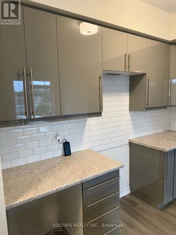 Brantford townhouse for rent - A kitchen with a counter top and cabinets.
