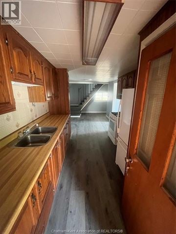 Wallaceburg apartment for rent - A kitchen with wooden cabinets and a sink.