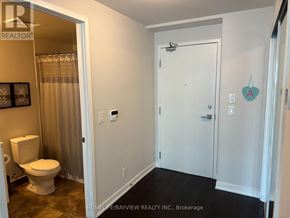 Toronto (Waterfront Communities) condo for rent - A white bathroom with a toilet and a shower curtain.