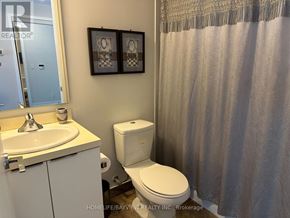Toronto (Waterfront Communities) condo for rent - A white toilet sits next to a sink in a bathroom.