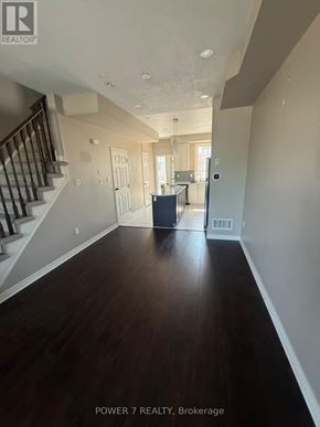 Toronto (West Hill) townhouse for rent - A spacious hallway with wood flooring and a staircase.