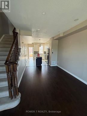 Toronto (West Hill) townhouse for rent - A spacious hallway with a staircase on the left and a doorway leading to another room on the right.