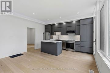 Toronto (Greenwood-Coxwell) apartment for rent - A modern kitchen with dark grey cabinets and a wooden floor.