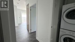 Vaughan (Steeles West Industrial) condo for rent - A laundry room with a washer and dryer.
