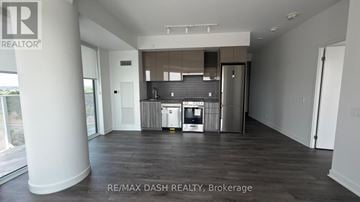 Vaughan (Steeles West Industrial) condo for rent - A spacious room with a kitchenette and a refrigerator.