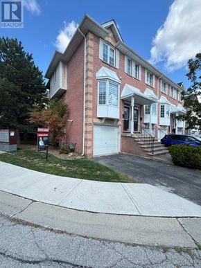 Burlington (Palmer) townhouse for rent - A red brick house with a white garage door.