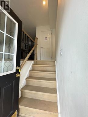 Burlington (Palmer) townhouse for rent - A staircase with a black door and a glass window.
