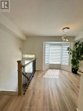 Burlington (Palmer) townhouse for rent - A well-lit room with wooden floors and a staircase.
