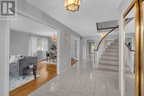 Hamilton (Butler) apartment for rent - A living room with a grey couch and a chandelier.