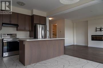 Brantford apartment for rent - A kitchen with a stove top oven and a refrigerator.