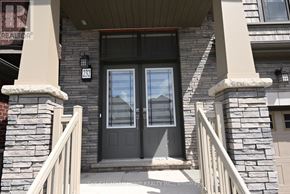 Brantford apartment for rent - A house with a grey front door and stone pillars.