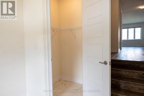 Brantford apartment for rent - A white door is open to a room with a wooden floor.