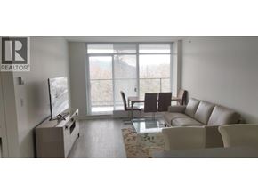 Burnaby apartment for rent - A living room with a couch, chairs, and a television.
