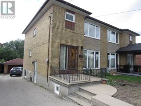 Toronto (Brookhaven-Amesbury) apartment for rent - A brick house with a black iron fence in front.