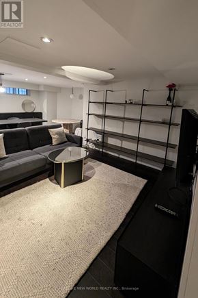 Toronto (South Parkdale) apartment for rent - A modern living room with a grey sofa and a round coffee table.