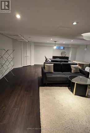 Toronto (South Parkdale) apartment for rent - A living room with a black couch and a round table.