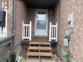 Kitchener townhouse for rent - A small porch with a white door and steps leading up to it.