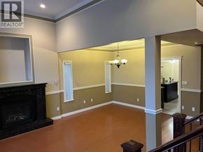 Burnaby apartment for rent - A living room with a fireplace and a chandelier.