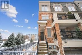 Oakville (Wm Westmount) townhouse for rent - A building with a balcony and a snowy landscape in the background.