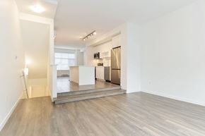 Surrey townhouse for rent - A spacious living room with a kitchen in the background.