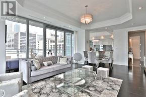 Toronto (Annex) condo for rent - A living room with a glass table and a grey couch.