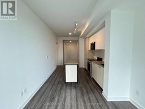 Toronto (Church-Yonge Corridor) condo for rent - A white room with a kitchen area in the background.
