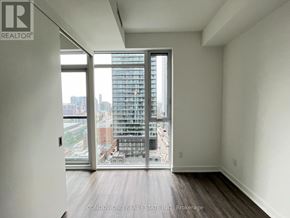Toronto (Church-Yonge Corridor) condo for rent - A room with a view of a cityscape through a large window.