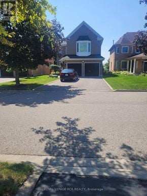 Newmarket (Armitage) apartment for rent - A black car is parked in front of a house.