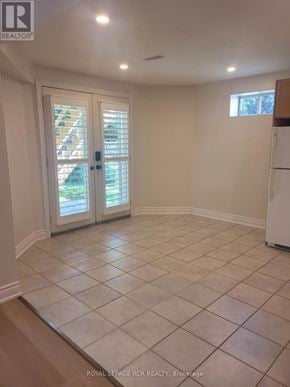 Newmarket (Armitage) apartment for rent - A white tiled kitchen with a white fridge and a door leading outside.