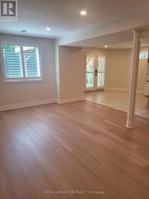 Newmarket (Armitage) apartment for rent - A spacious room with wooden flooring and a large window with shutters.
