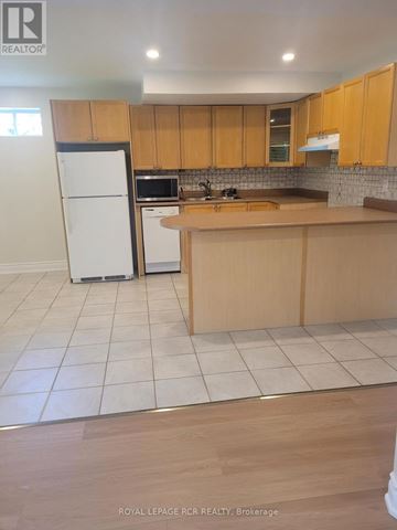 Newmarket (Armitage) apartment for rent - A kitchen with wooden cabinets and a white fridge.