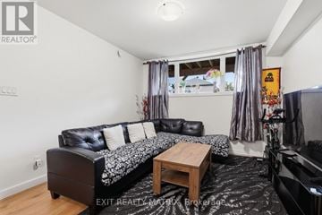 The Nation fourplex for rent - A living room with a black couch and a coffee table.