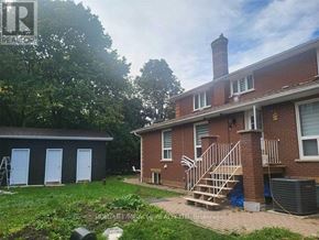 Uxbridge apartment for rent - A red brick house with a white door and a blue garage door.