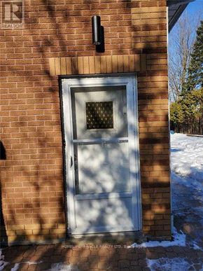 Uxbridge apartment for rent - A door with a glass window is set in a brick wall.