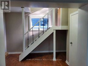 Uxbridge apartment for rent - A staircase with a metal railing and wooden steps.