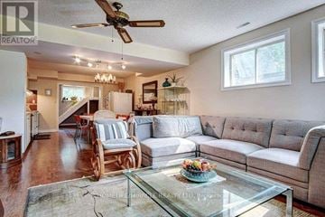 Uxbridge apartment for rent - A living room with a glass coffee table and a grey sofa.