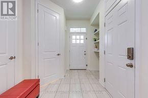 Oakville (Go Glenorchy) townhouse for rent - A hallway with white doors and a red bench.