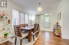 Oakville (Go Glenorchy) townhouse for rent - A dining room with a wooden table and chairs.