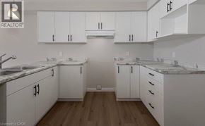 Stratford townhouse for rent - A kitchen with white cabinets and marble countertops.